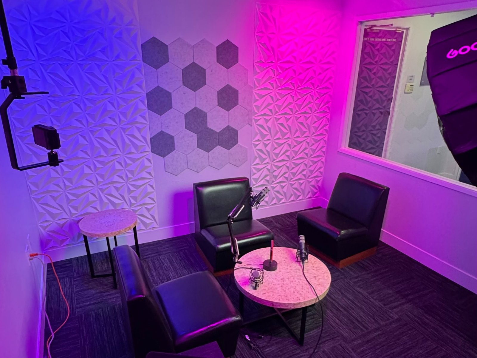 The B-OSS podcast studio with microphones, acoustic panels and studio lighting