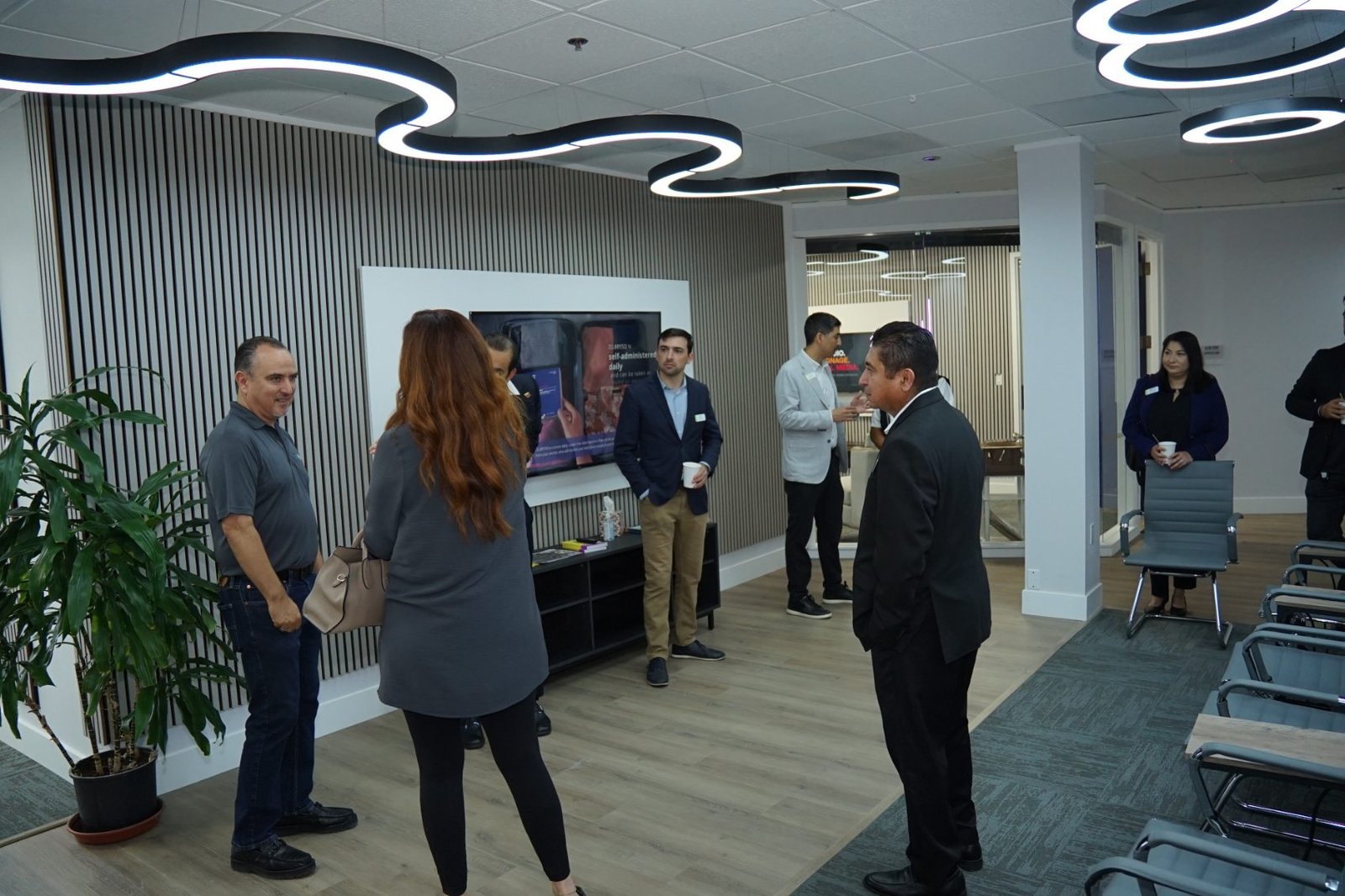Guests networking in the B-OSS media lounge during the opening